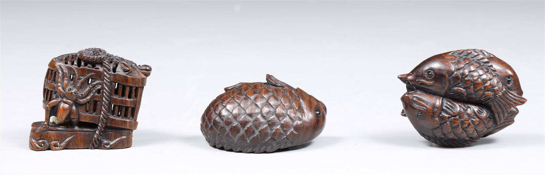 Group of three carved wood netsuke,