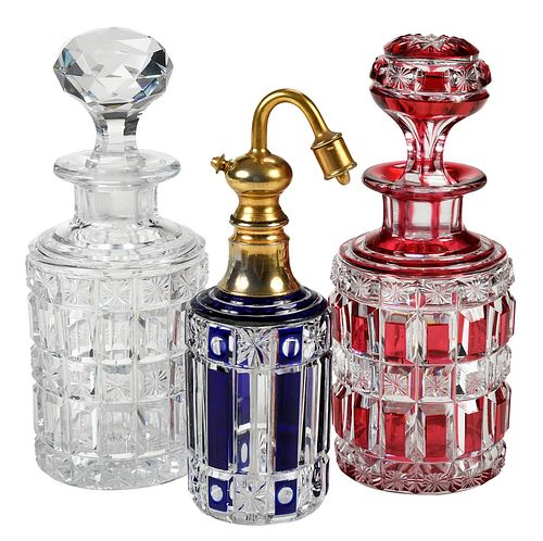 GROUP OF THREE CUT GLASS BOTTLES,