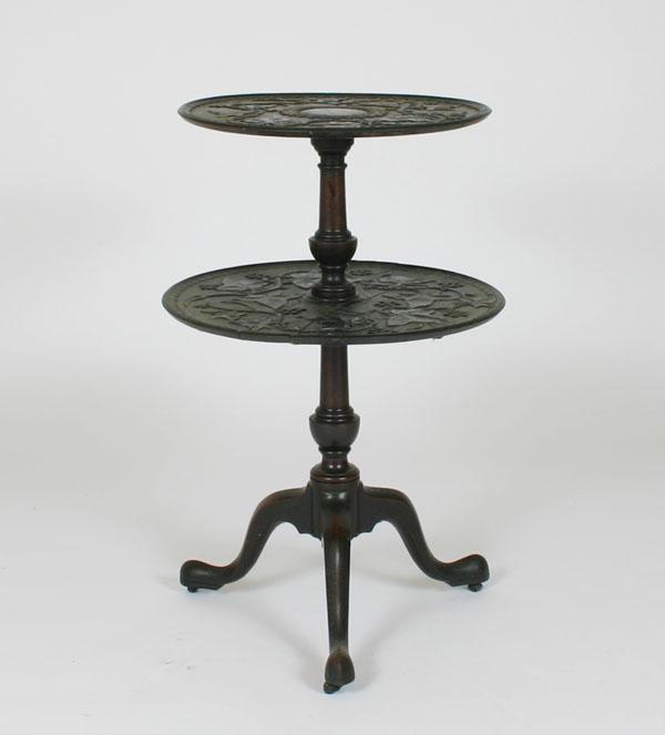 Heavily carved two-tier table;