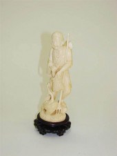 IVORY CARVING OF A FISHERMAN.