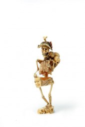 IVORY CARVING OF A SKELETON.