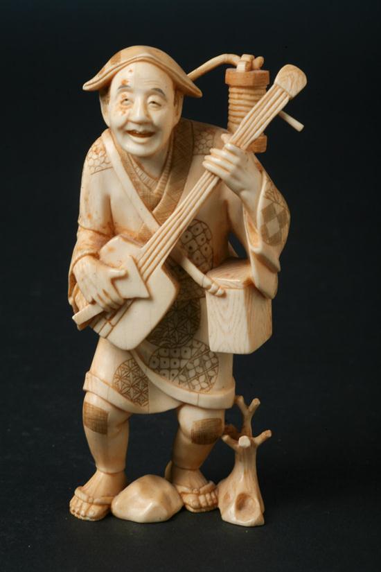 JAPANESE IVORY OKIMONO OF MUSICIAN.