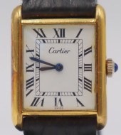 JEWELRY. CARTIER GOLD TONE TAN