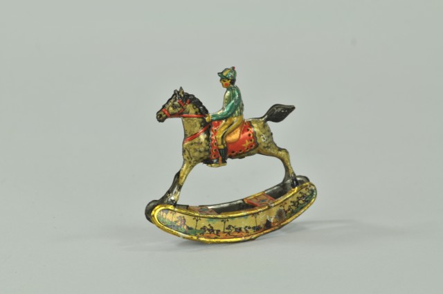 JOCKEY ON HORSE ROCKING PENNY TOY