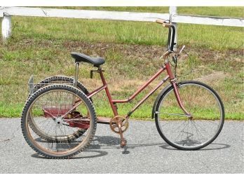 Large tricycle in red paint, with