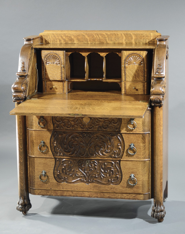 LATE VICTORIAN CARVED OAK SLANT-TOP