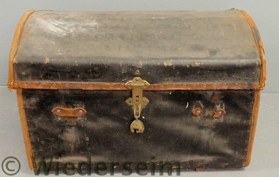 Leather-bound trunk fitted with a