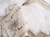 Linens including embroidered p