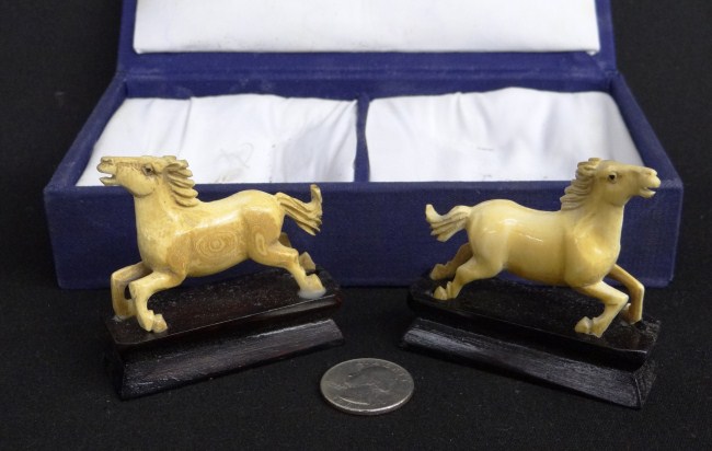 Lot 2 cased Asian ivory horses.
