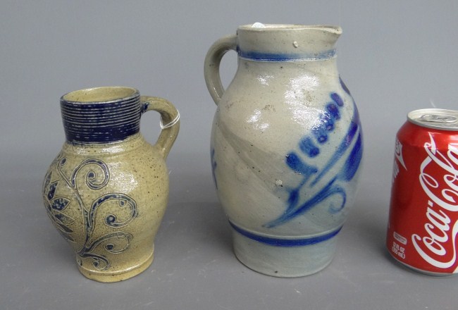 Lot (2) decorated stoneware jugs.