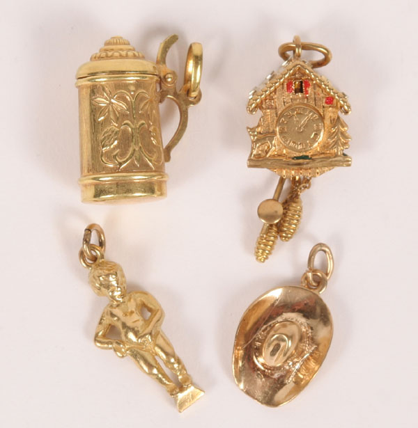Lot of four gold charms; child