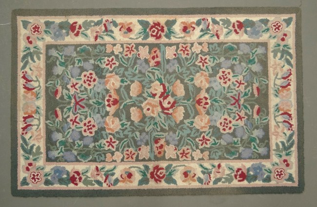 Machine made floral hooked rug.