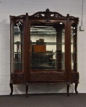 Mahogany china closet with orn