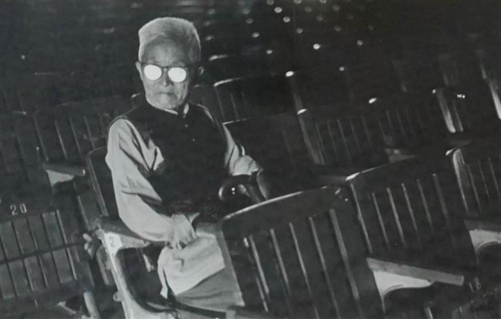 MAN SEATED IN BALLPARK STADIUM,