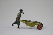 MAN WITH PIPE AND WHEELBARROW