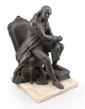 METAL SCULPTURE OF A SEATED BE