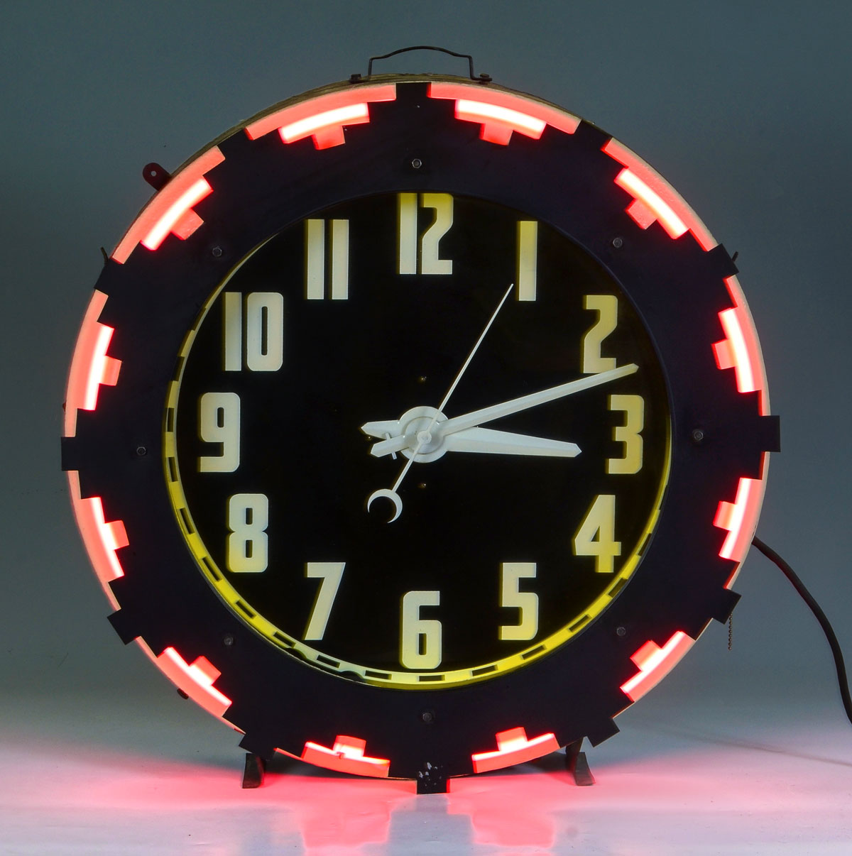 MID CENTURY NEON AZTEC CLOCK: Circa