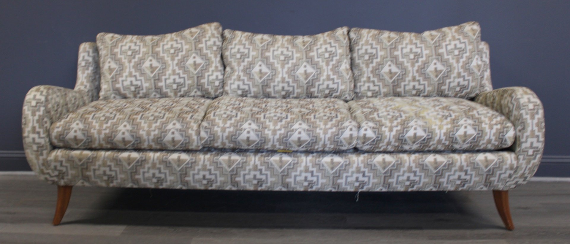 MIDCENTURY UPHOLSTERED SOFA. From a