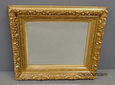 Mirror with an ornate gilt frame