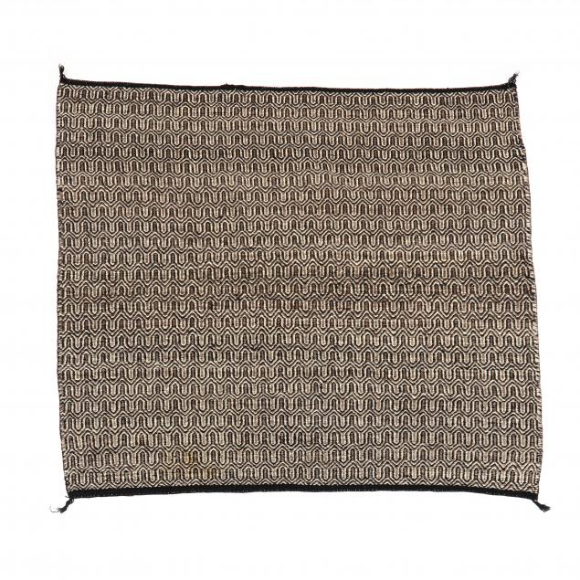 NAVAJO AREA RUG Woven in brown,