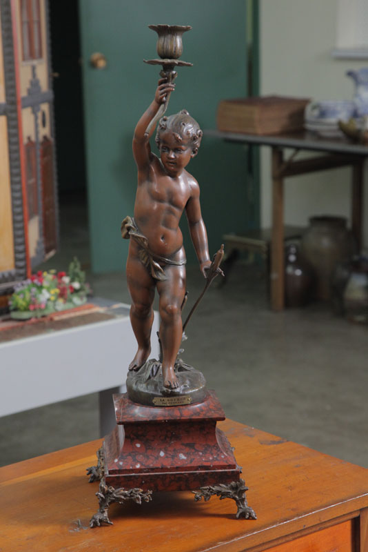 NEWELL POST LAMP. A cherub with