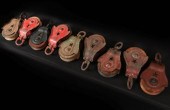 NINE ANTIQUE IRON PULLEYS WITH