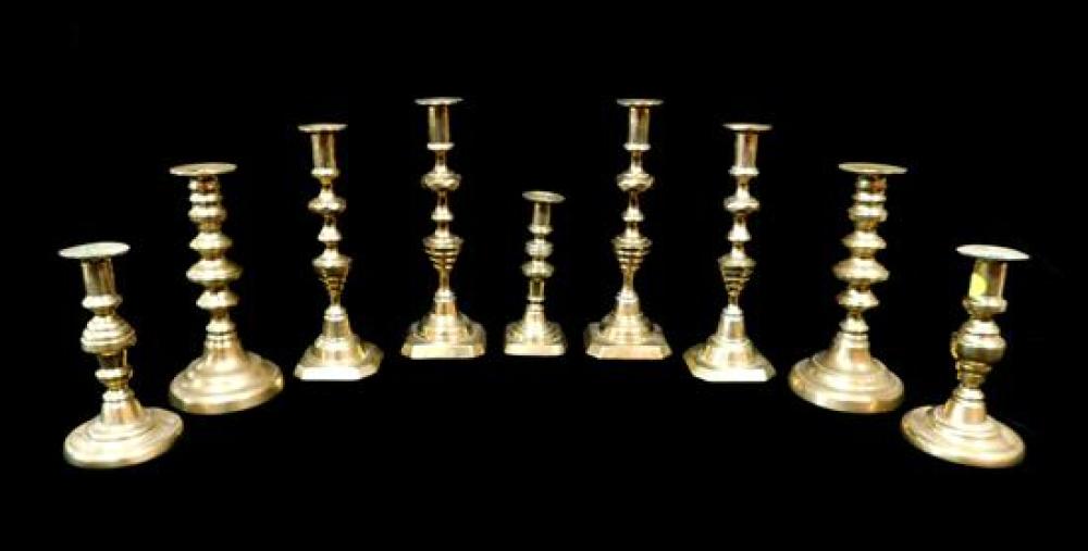 NINE EARLY BRASS CANDLESTICKS