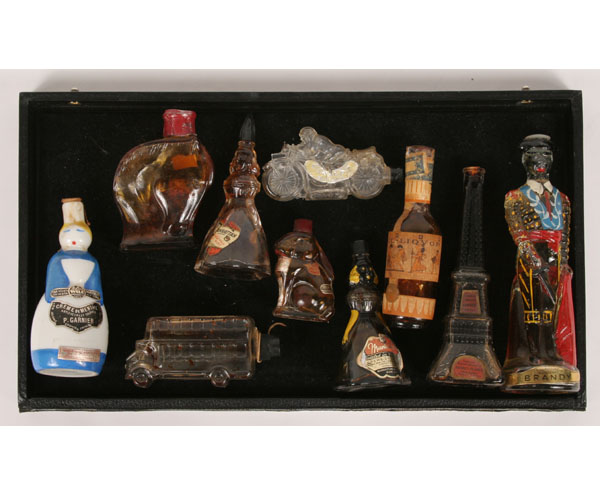Nine figural bottles including