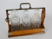 OAK AND CRYSTAL TANTALUS SET,