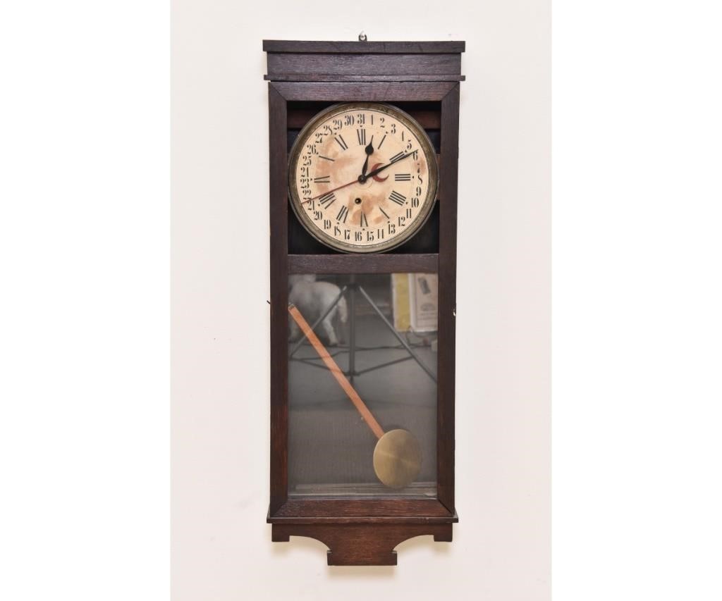 Oak-faced calendar wall clock.