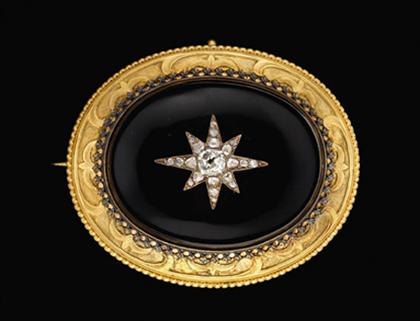 Onyx and diamond starburst brooch
