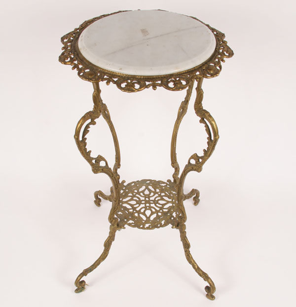 Ornate cast brass stand; curved