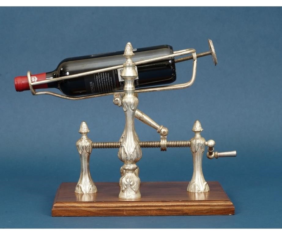 Ornate metal wine pourer with screw