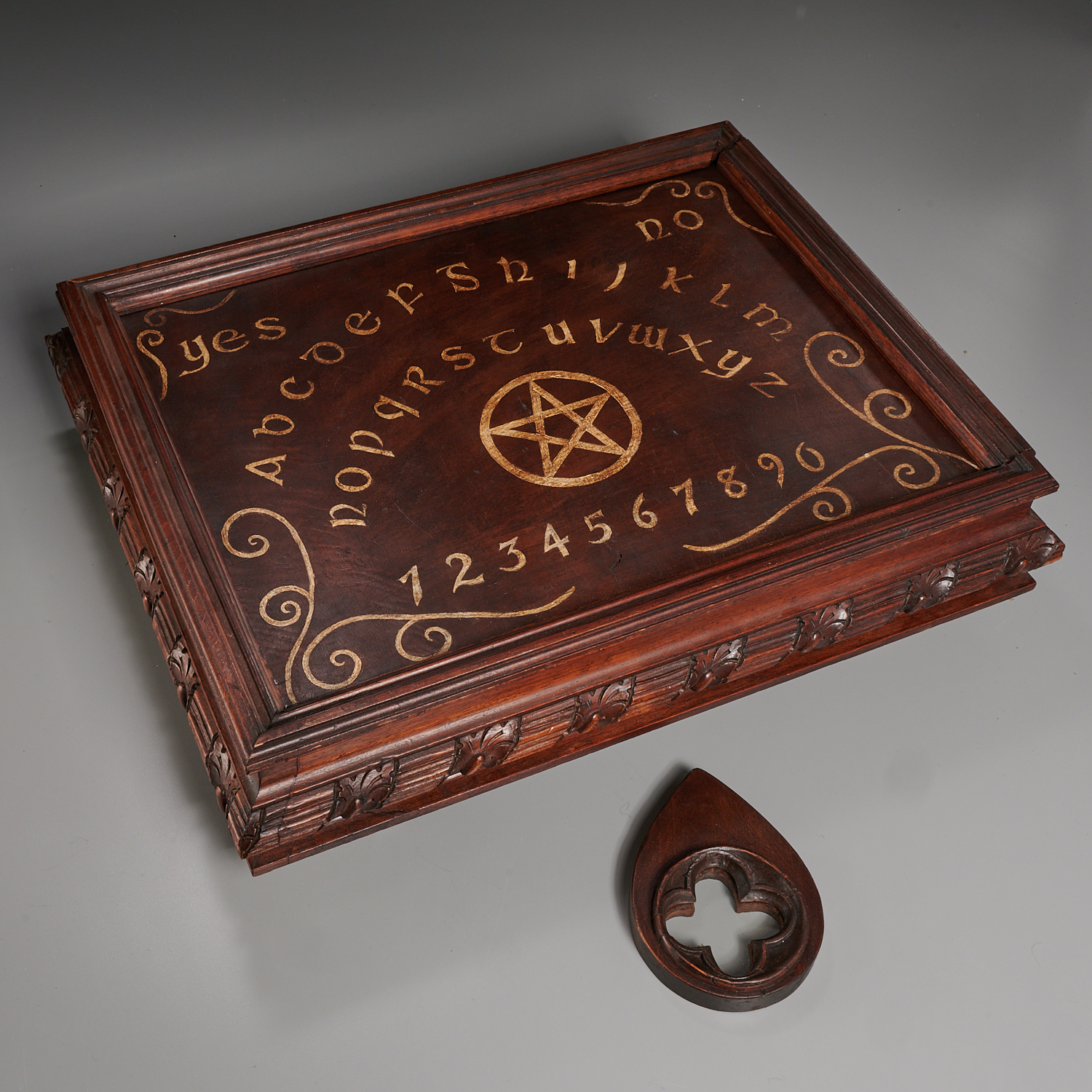 ORNATELY CARVED OUIJA BOARD IN