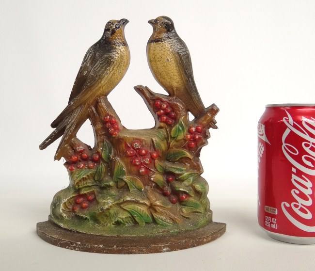 Painted swallows on stump doorstop.