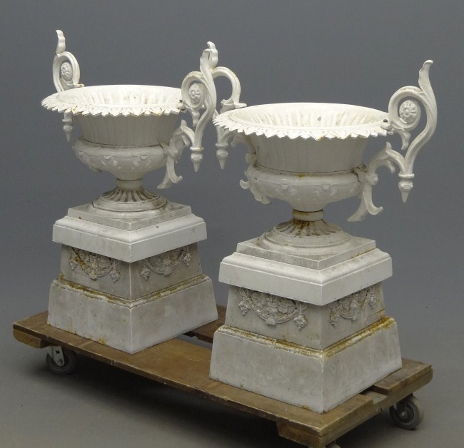 Pair cast iron multi-part urns.