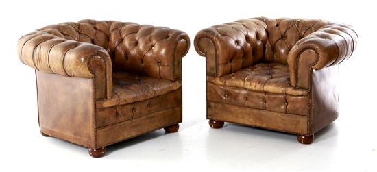 Pair leather club chairs typical