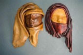 PAIR LEATHER SCULPTURED FACES