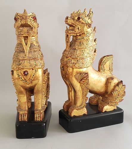 PAIR OF CARVED AND GILT TIBETAN FOO