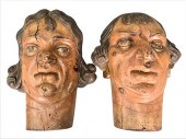PAIR OF CARVED GROTESQUE HEADS