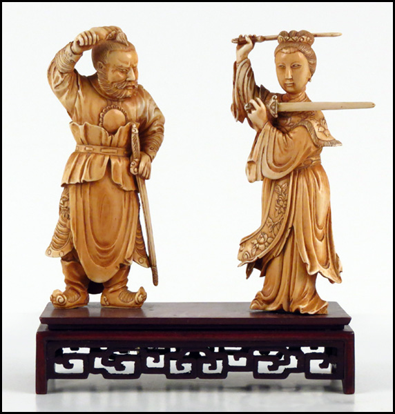 PAIR OF CARVED IVORY FIGURES OF A