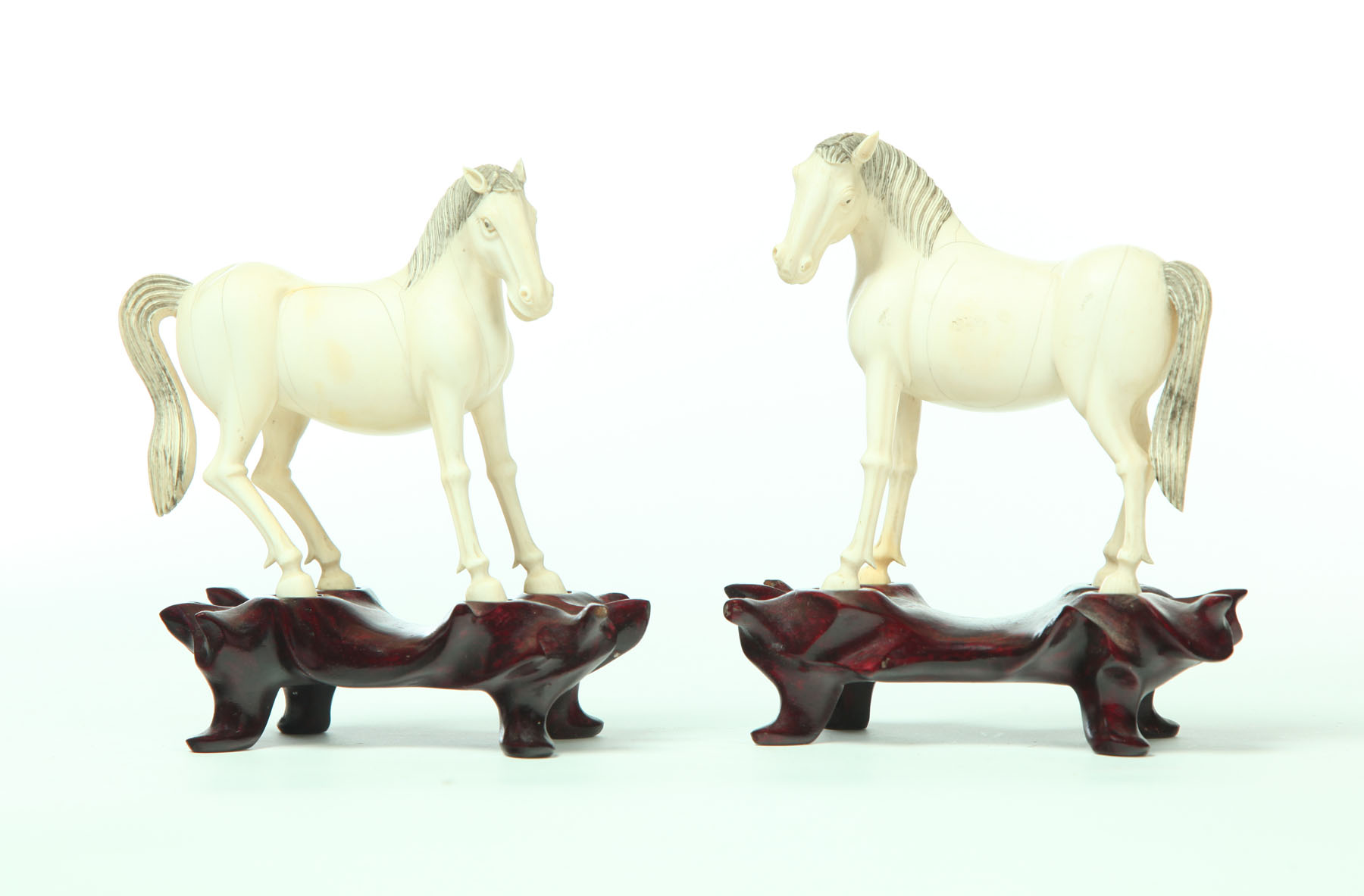 PAIR OF CARVED IVORY HORSES.  China