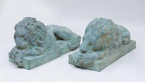 PAIR OF CAST-IRON RECUMBENT