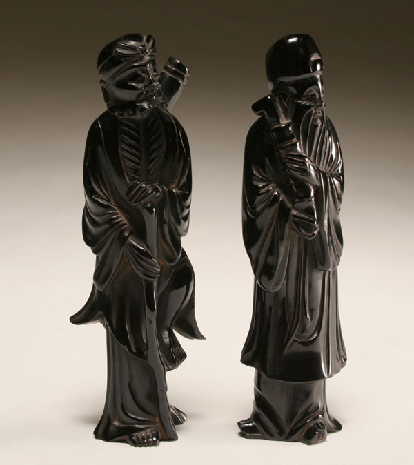Pair of dark red amber carved