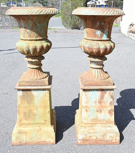 PAIR OF IRON URNS ON SQUARE