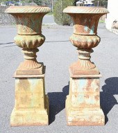 PAIR OF IRON URNS ON SQUARE PE