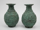 PAIR OF PATINATED BRONZE BALUS