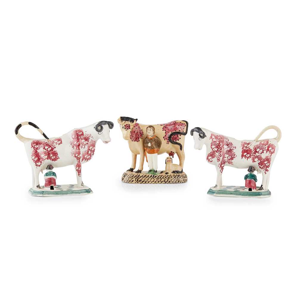 PAIR OF POTTERY COW CREAMERS