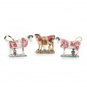 PAIR OF POTTERY COW CREAMERS
E