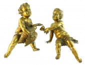 PAIR OF SEATED BRASS PUTTI FIG